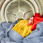Inside of tumble dryer with drying laundry